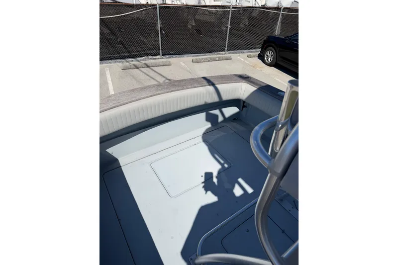 Slide: The Image of 2020 Strike 26' Center Console Cuddy boat interior, docked in a parking area. - 13