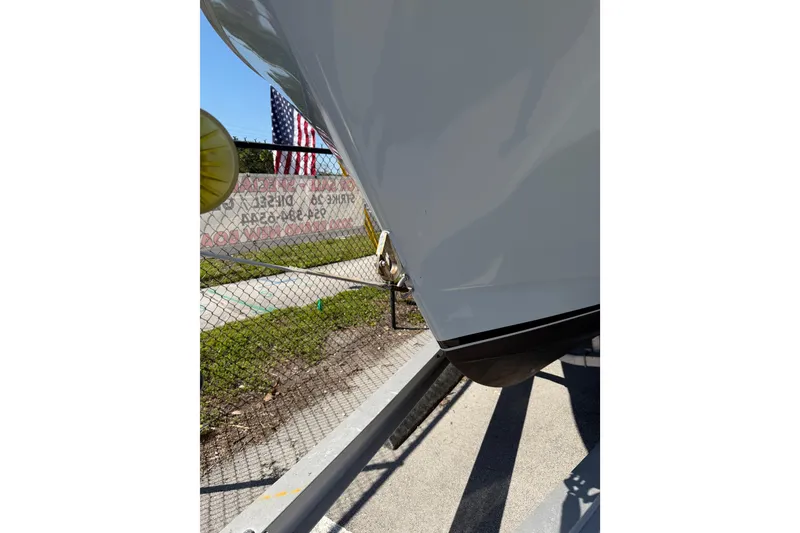 Slide: The Image of 2020 Strike 26' Center Console Cuddy boat on trailer, American flag in background. - 15
