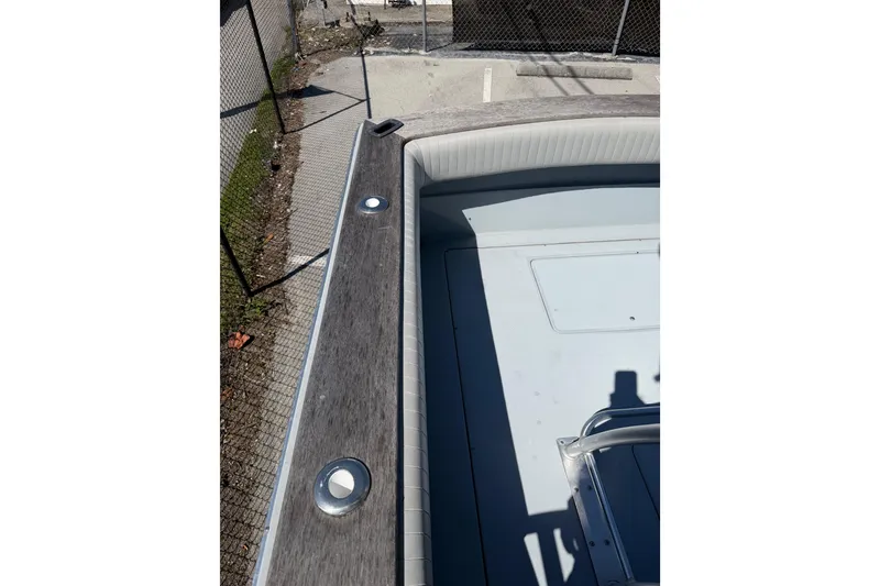 Slide: The Image of 2020 Strike 26' Center Console Cuddy boat deck with seating and rod holders. - 17