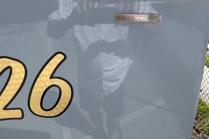 Slide: The Image of Strike 26' Center Console Cuddy 2020 boat hull with reflective surface and serial number. - 18