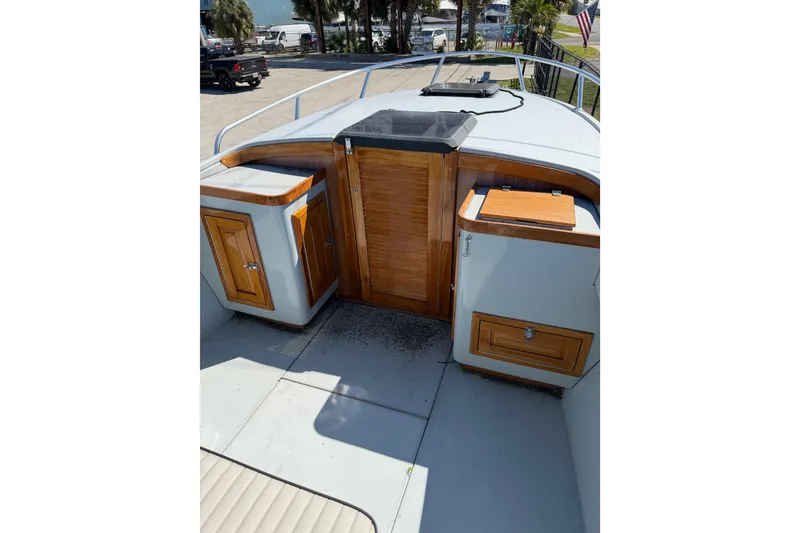 Slide: The Image of 2020 Strike 26' Center Console Cuddy with wooden cabinetry and deck view. - 2