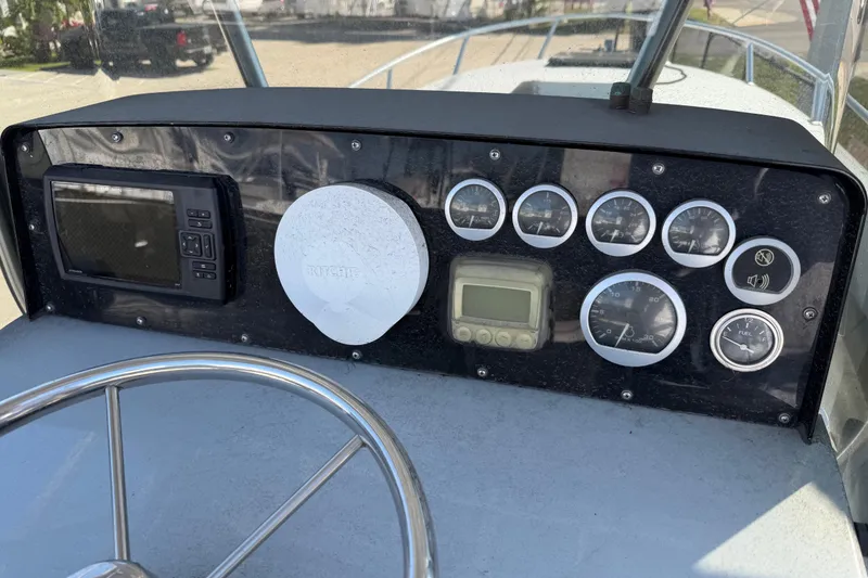 Slide: The Image of Dashboard of a 2020 Strike 26' Center Console Cuddy boat with gauges and controls. - 4