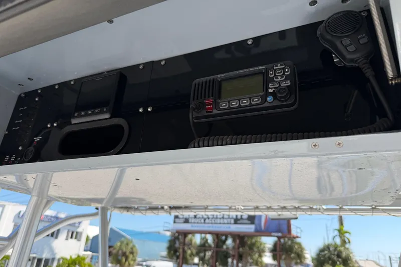 Slide: The Image of 2020 Strike 26' Center Console Cuddy boat dashboard with radio and controls. - 6