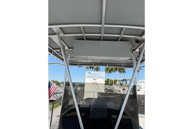 Slide: The Image of 2020 Strike 26' Center Console Cuddy boat with T-top and American flag. - 8