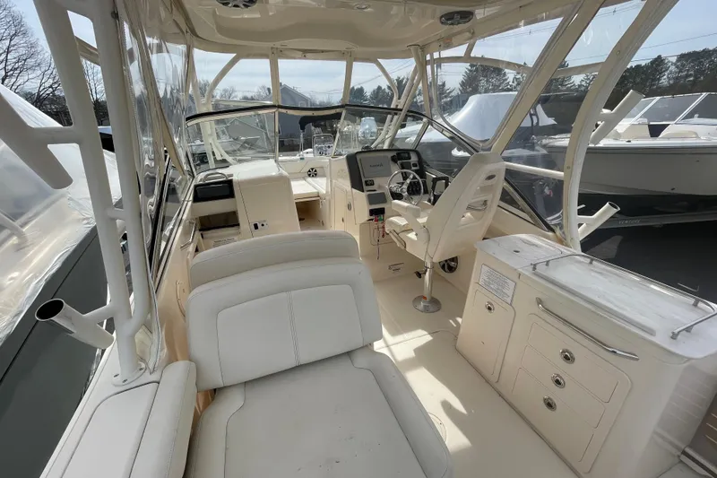 Slide: The Image of 2017 Grady-White Freedom 275 boat interior with helm, seating, and storage compartments. - 11