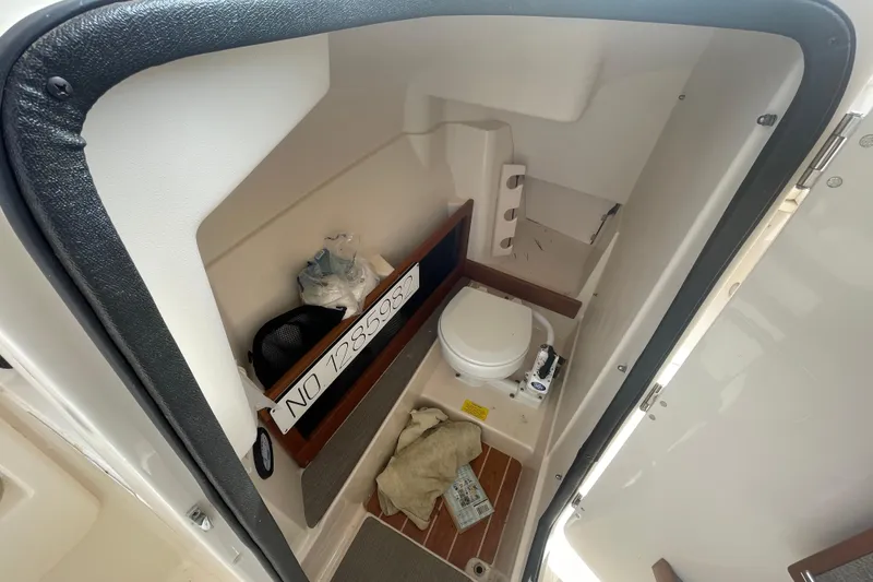Slide: The Image of Interior view of a 2017 Grady-White Freedom 275 boat's compact bathroom area. - 15
