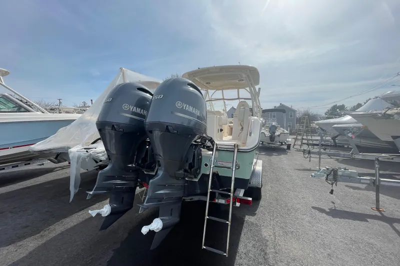 Slide: The Image of 2017 Grady-White Freedom 275 boat with twin Yamaha engines, docked outdoors. - 5