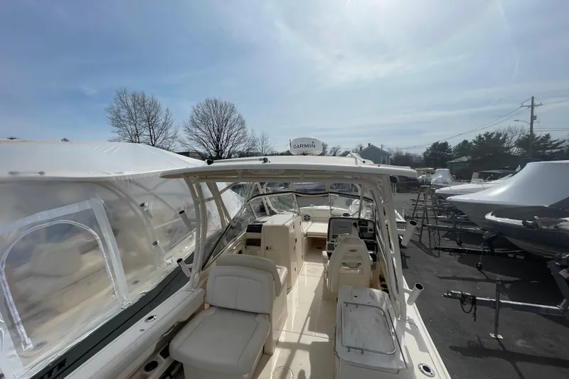 Slide: The Image of 2017 Grady-White Freedom 275 boat in storage, featuring spacious seating and Garmin equipment. - 6