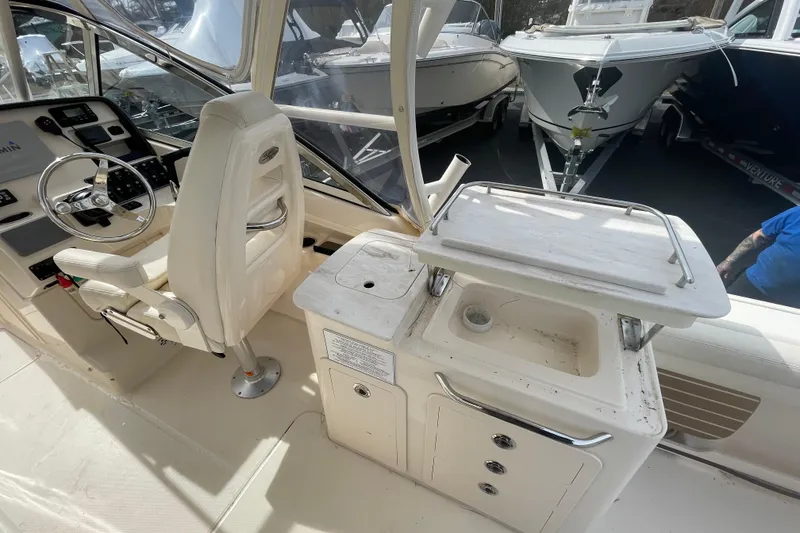 Slide: The Image of 2017 Grady-White Freedom 275 boat interior with helm and sink station. - 9