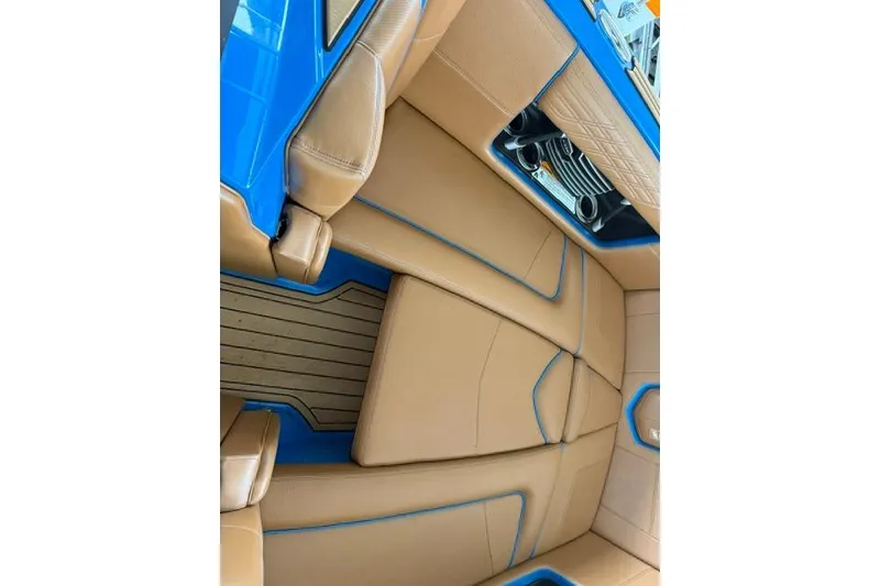 Slide: The Image of 2020 Nautique Super Air Nautique G25 interior with tan leather and blue accents. - 12