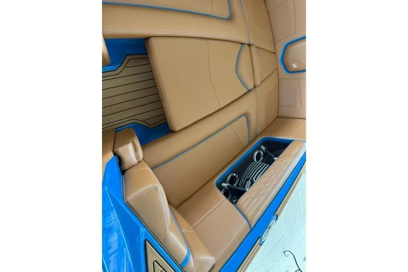 Slide: The Image of 2020 Nautique Super Air Nautique G25 interior with tan and blue upholstery. - 13