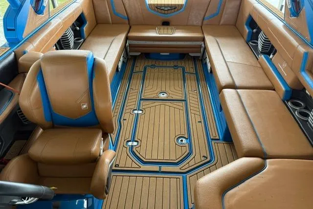 Slide: The Image of Luxurious interior of 2020 Nautique Super Air Nautique G25 boat with tan and blue seating. - 14