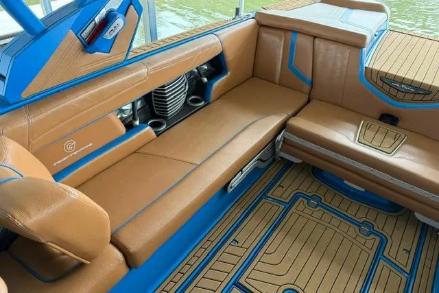 Slide: The Image of 2020 Nautique Super Air Nautique G25 interior with tan and blue seating. - 15