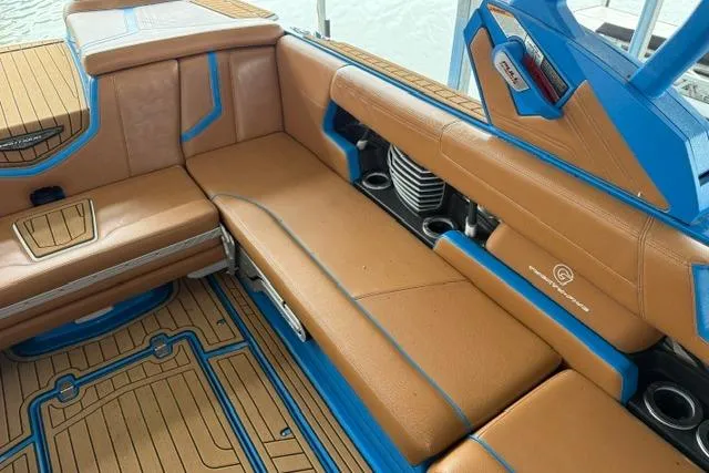 Slide: The Image of 2020 Nautique Super Air Nautique G25 interior with tan and blue seating. - 16