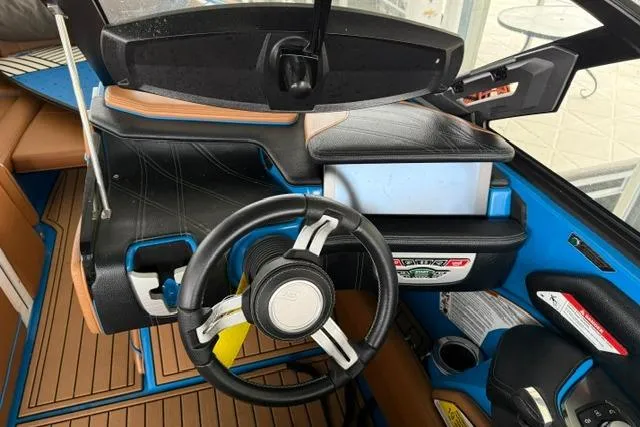 Slide: The Image of 2020 Nautique Super Air Nautique G25 dashboard with steering wheel and control panel. - 19