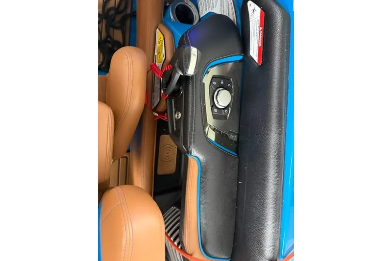 Slide: The Image of 2020 Nautique Super Air Nautique G25 dashboard with control panel and tan seating. - 32
