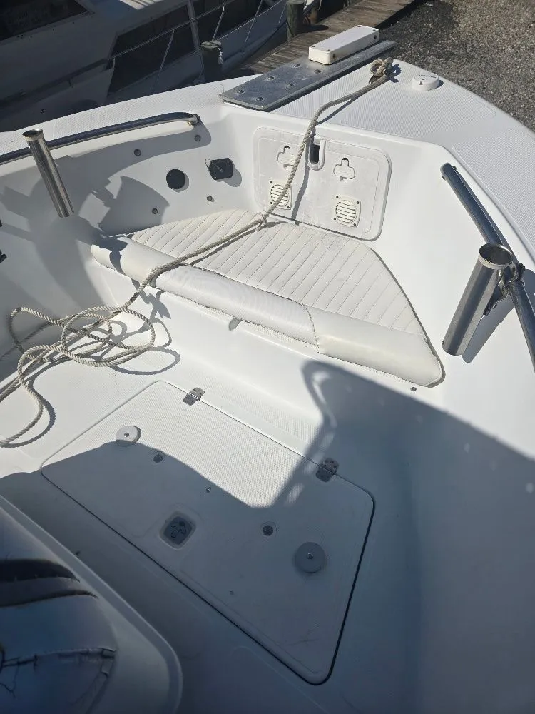Slide: The Image of 2004 Polar 2100 CC Center Console boat deck with seating and rope. - 9