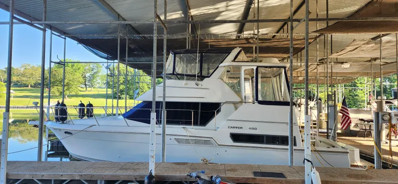 The Image of 1996 Carver 400 Cockpit Motor Yacht docked in a covered marina. - 1