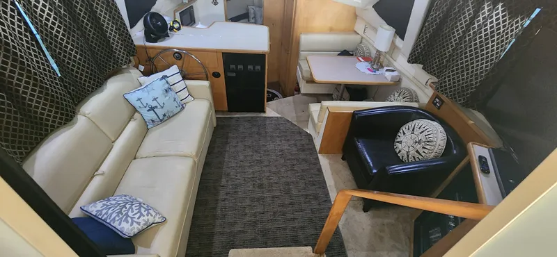 Slide: The Image of Interior of 1996 Carver 400 Cockpit Motor Yacht with cozy seating and modern decor. - 14