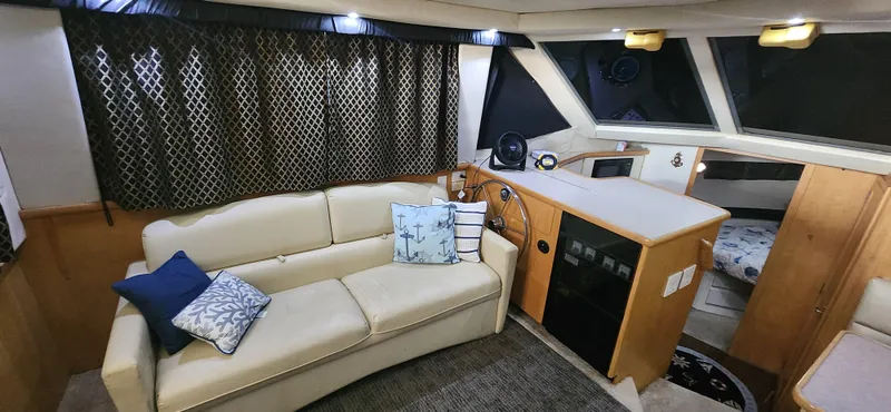 Slide: The Image of Interior of 1996 Carver 400 Cockpit Motor Yacht with sofa and helm station. - 15