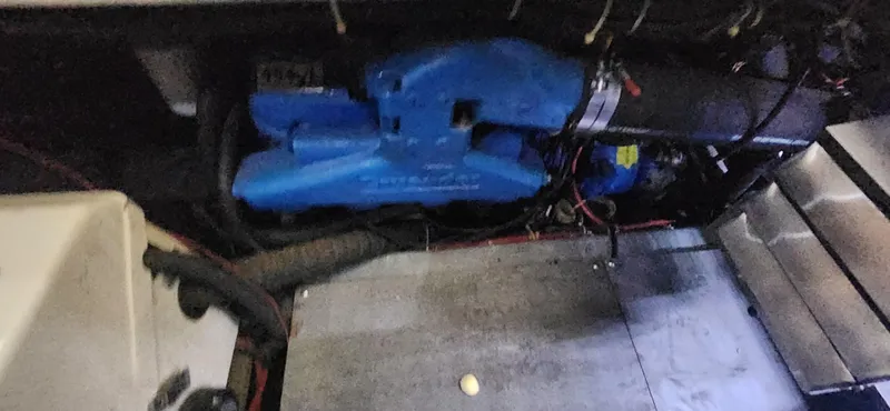 Slide: The Image of Engine compartment of 1996 Carver 400 Cockpit Motor Yacht, featuring blue engine components. - 25