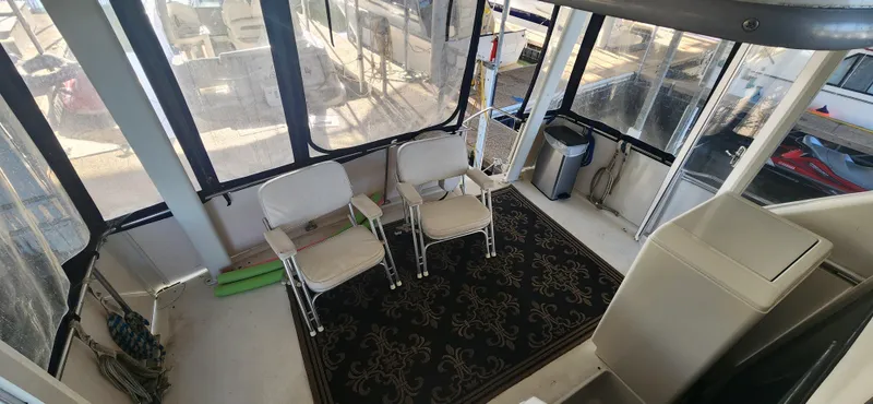 Slide: The Image of Interior of 1996 Carver 400 Cockpit Motor Yacht with chairs and carpet. - 7