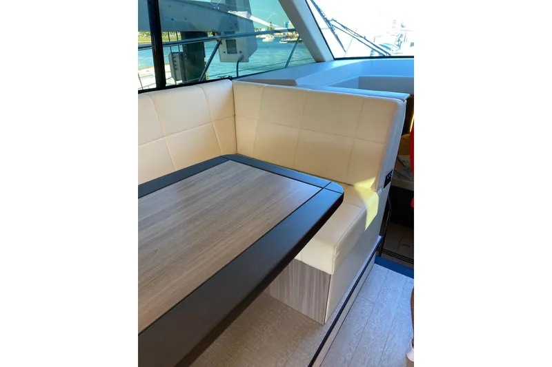 Slide: The Image of Luxurious interior seating on 2021 Regal 42 XO yacht with elegant table design. - 2