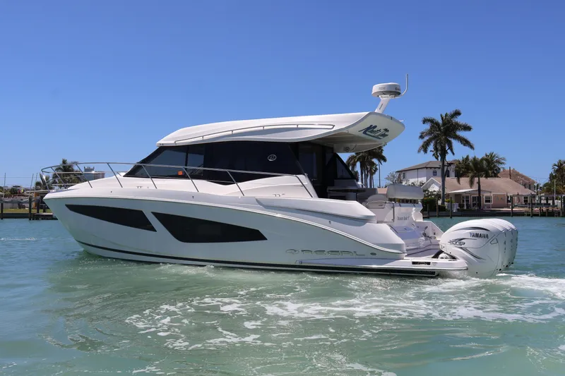 Slide: The Image of Outdoor kitchen area on a 2021 Regal 42 XO yacht with grill and seating. - 24