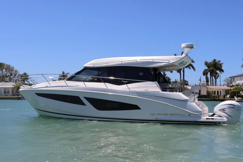 Slide: The Image of Outdoor grill on a 2021 Regal 42 XO yacht, docked by the water. - 25