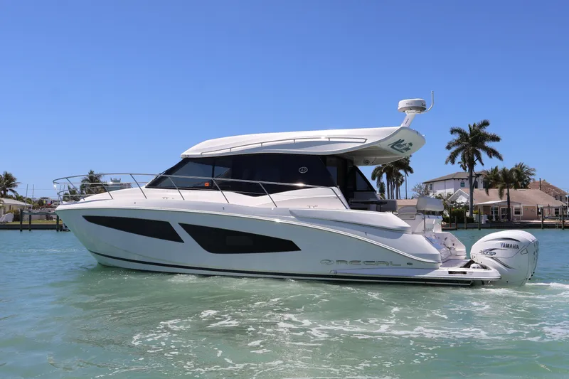 Slide: The Image of Outdoor grill and seating area on 2021 Regal 42 XO yacht by the water. - 26