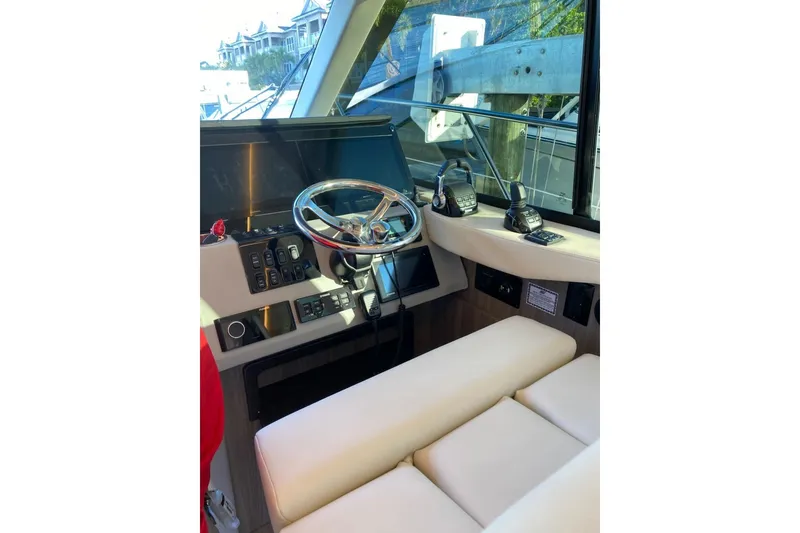 Slide: The Image of Helm of 2021 Regal 42 XO yacht with modern controls and leather seating. - 3