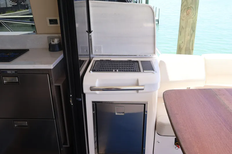 Slide: The Image of Luxurious seating area on 2021 Regal 42 XO yacht with elegant cushions and table. - 36