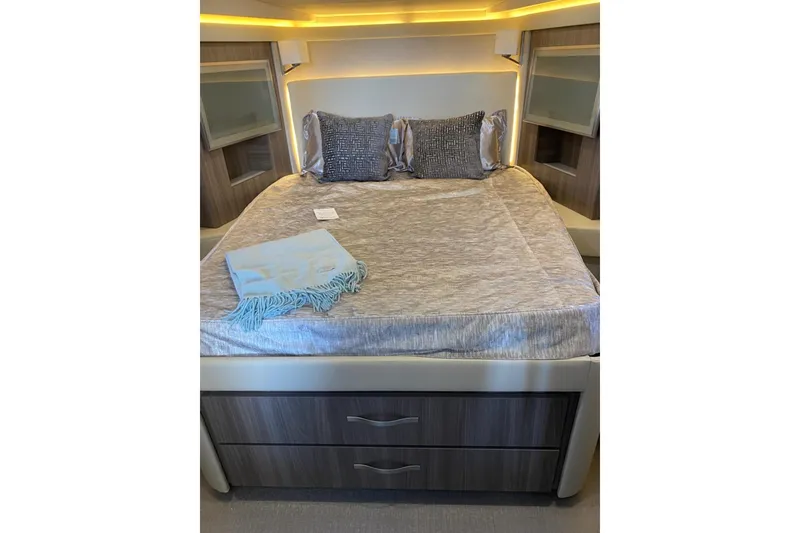 Slide: The Image of Luxurious bedroom interior of 2021 Regal 42 XO yacht with elegant bedding and ambient lighting. - 4