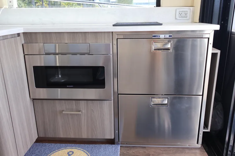 Slide: The Image of Control panel of a 2021 Regal 42 XO yacht, featuring advanced navigation controls. - 43