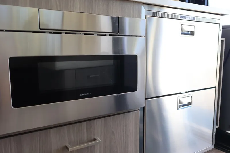 Slide: The Image of Control panel of 2021 Regal 42 XO yacht with joystick and trim tab controls. - 45