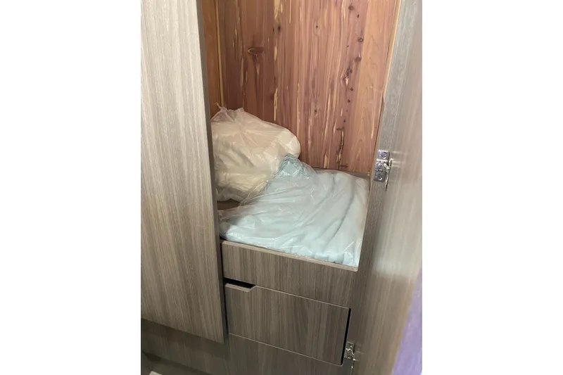 Slide: The Image of 2021 Regal 42 XO yacht interior storage compartment with wooden finish. - 5