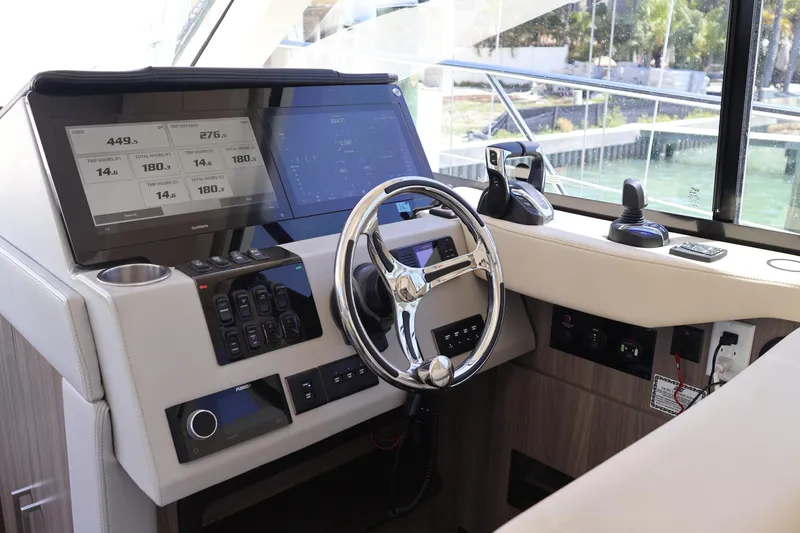 Slide: The Image of Electrical control panel inside a 2021 Regal 42 XO yacht, featuring switches and gauges. - 52