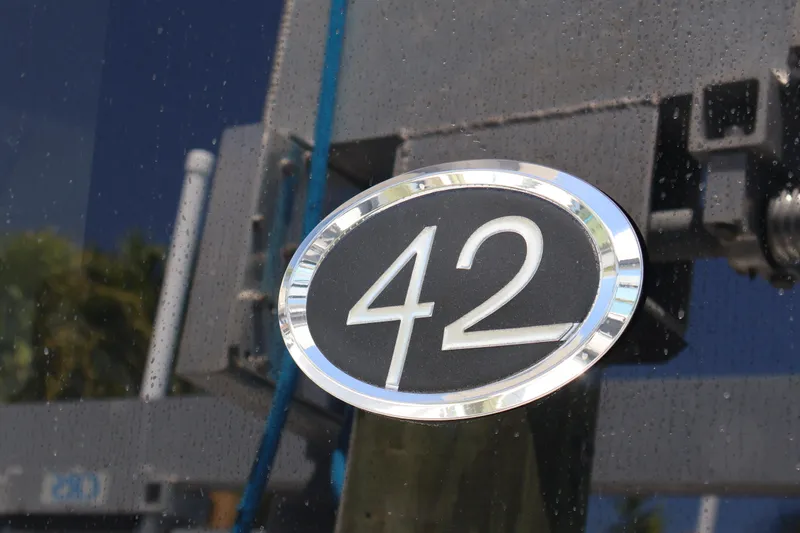 Slide: The Image of 2021 Regal 42 XO yacht bow with blue cover docked at marina. - 70