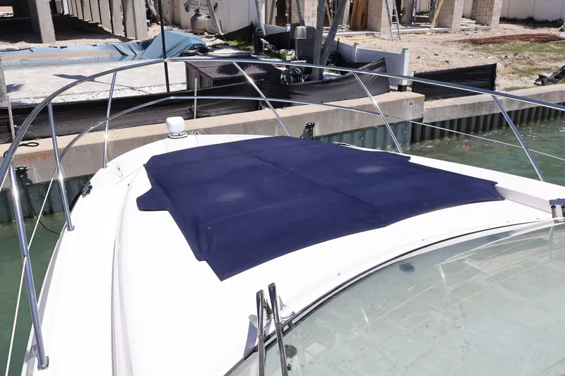 Slide: The Image of 2021 Regal 42 XO yacht docked by the water on a sunny day. - 71