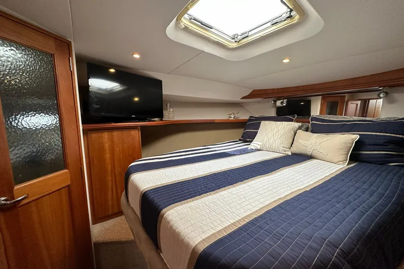 Slide: The Image of Luxurious cabin interior of 2001 Silverton 42 Convertible yacht with skylight and TV. - 12