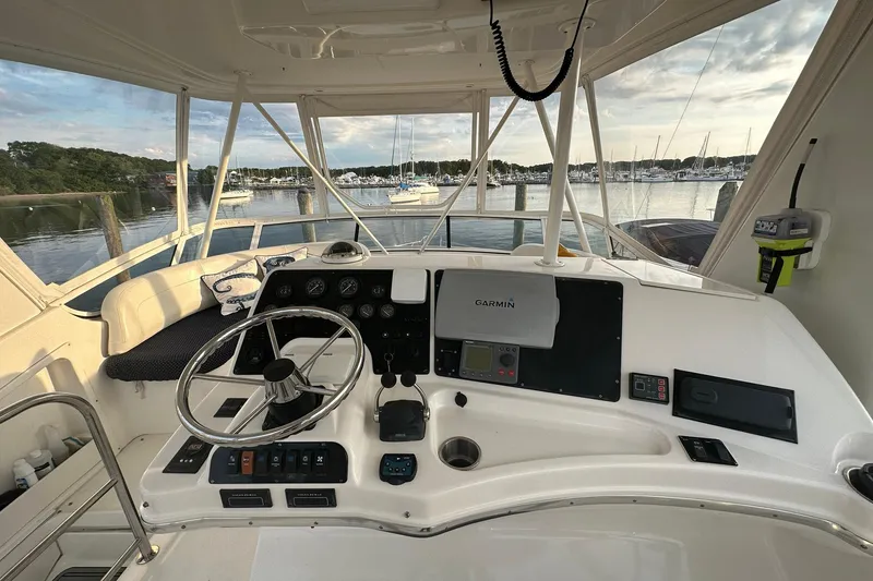 Slide: The Image of Cockpit view of 2001 Silverton 42 Convertible yacht with marina backdrop. - 5