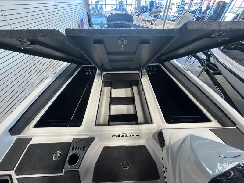 Slide: The Image of Falcon F215 boat with open storage compartments and 250HP Mercury ProXS. - 11