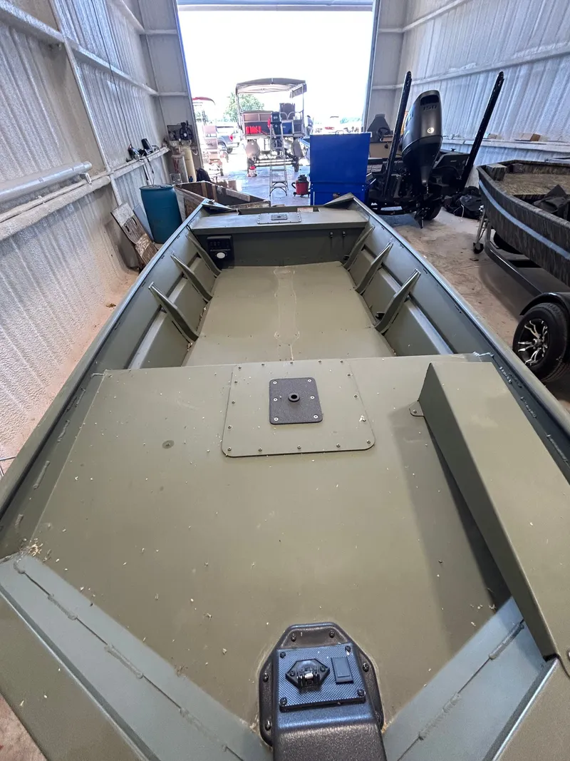 Slide: The Image of Interior view of a 2026 SeaArk 1448MV fishing boat in a garage. - 11