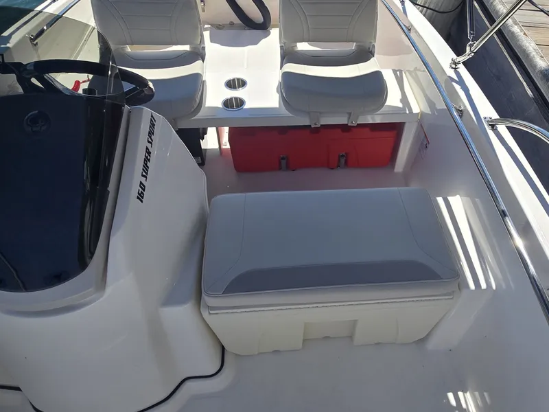 Slide: The Image of The image shows the cockpit of a Boston Whaler 160 Super Sport with white seats and a red cooler. - 14