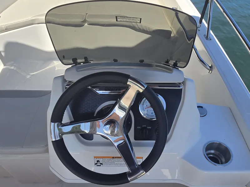 Slide: The Image of The image shows the helm of a 2026 Boston Whaler 160 Super Sport with a modern steering wheel. - 11