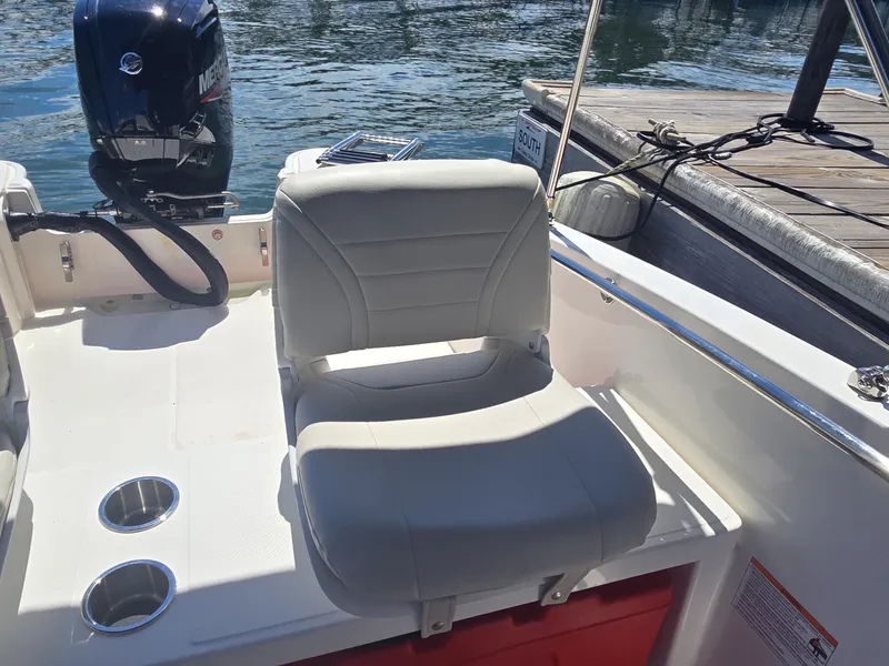Slide: The Image of A 2026 Boston Whaler 160 Super Sport with a comfortable seat and an outboard motor. - 8