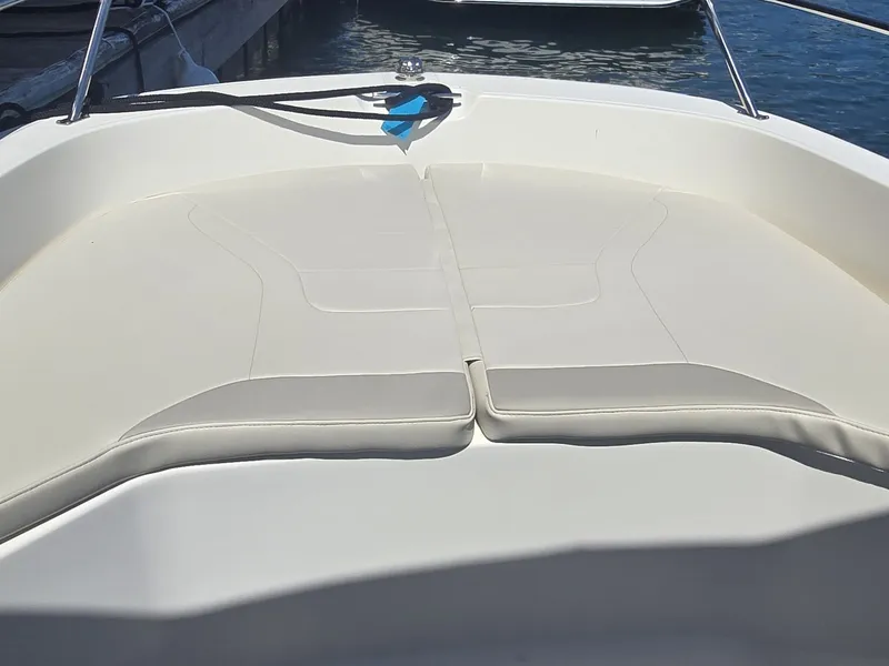Slide: The Image of The image shows the bow area of a Boston Whaler 160 Super Sport boat with beige cushions. - 17