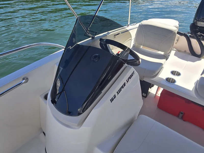Slide: The Image of The image shows the cockpit of a Boston Whaler 160 Super Sport with a modern steering wheel and comfortable seating. - 10
