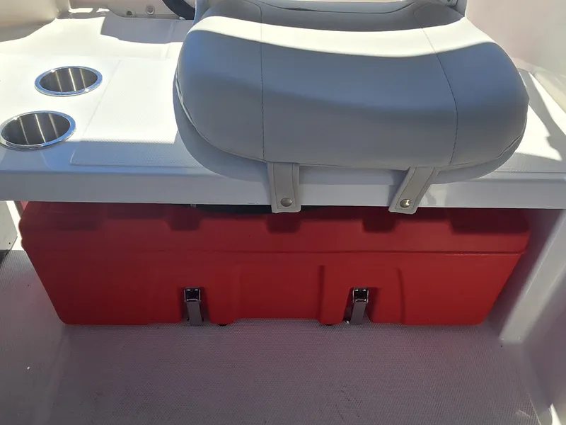 Slide: The Image of A gray seat with red storage underneath and two cup holders beside it. - 15