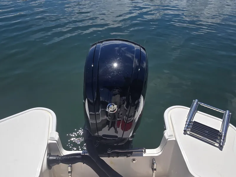 Slide: The Image of A 2026 Boston Whaler 160 Super Sport with an outboard motor and a swim ladder. - 6